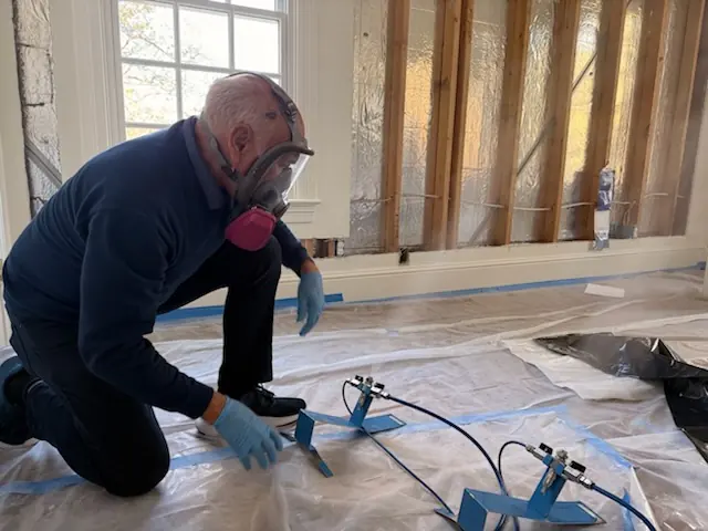 A restoration technician setting drying equipment in an Rancho Cucamonga home stripped to the studs